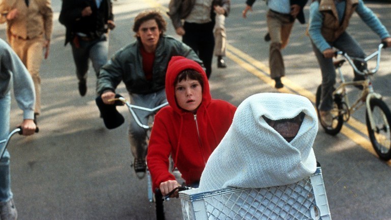Elliott and ET riding on bike in ET