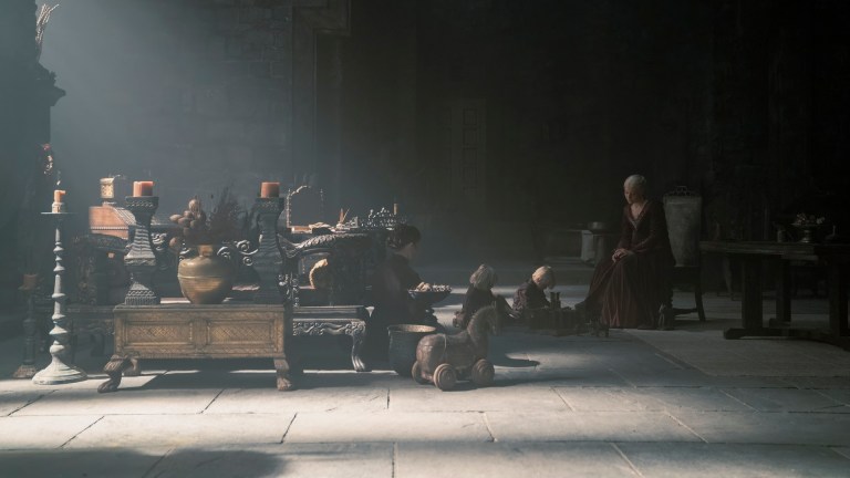 Queen Rhaenyra in a cavernous castle room with her children on House of the Dragon season 2.